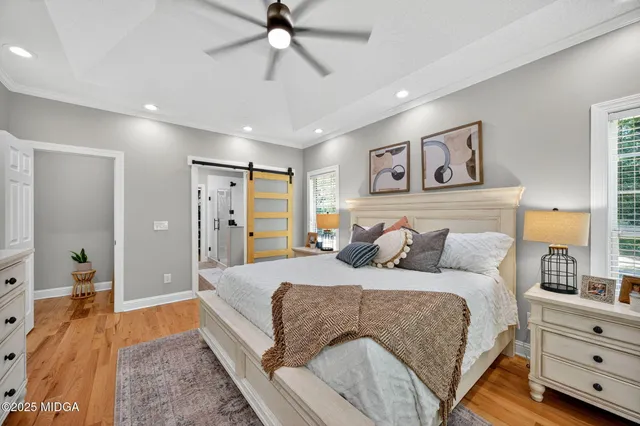 a bedroom with a large bed and a chandelier