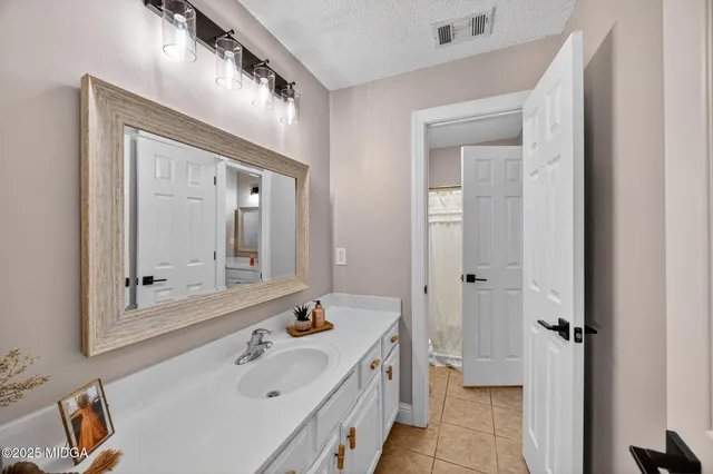 a bathroom with a tub sink and mirror
