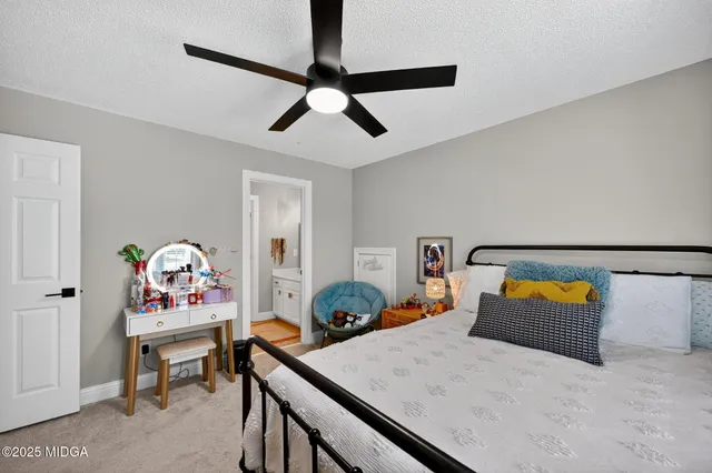 a bedroom with a bed and a dresser in it