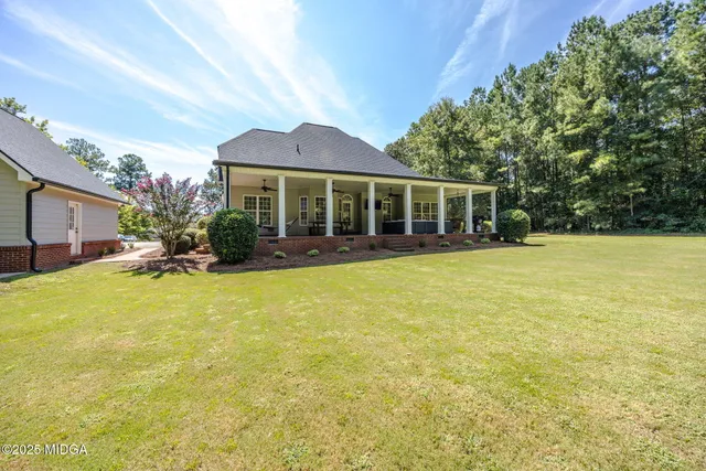 a view of a house with swimming pool and porch