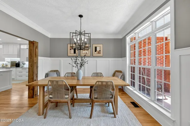 a view of a dining room with furniture window and wooden floor