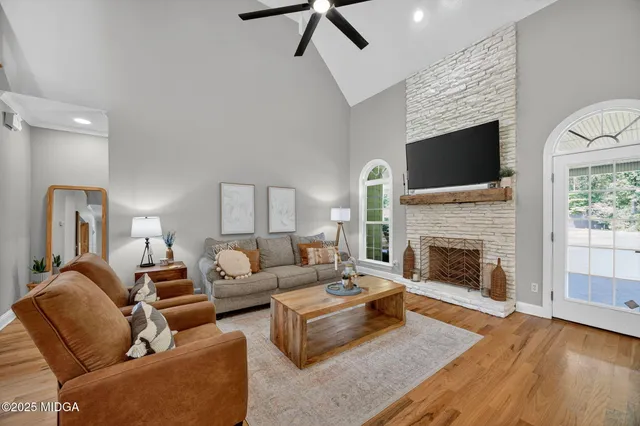 a living room with furniture fireplace and flat screen tv