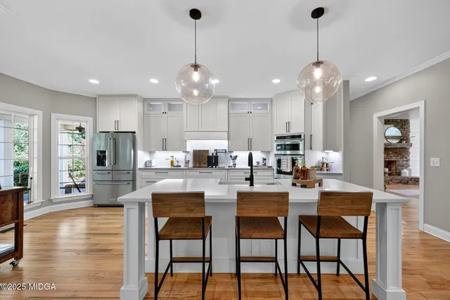 a large kitchen with a table and chairs