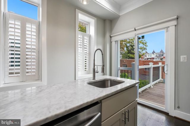 a kitchen with a sink and a large window
