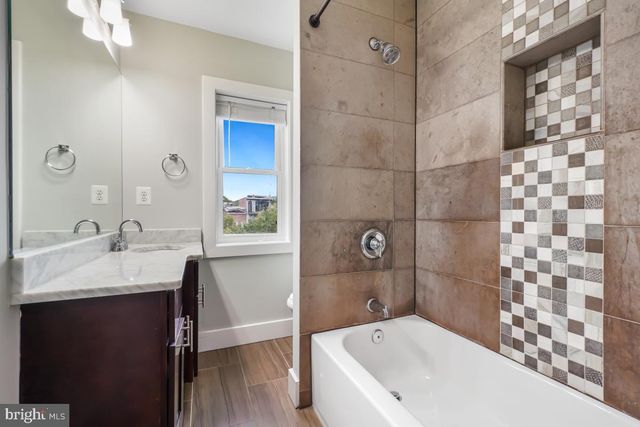 a bathroom with a bathtub and a sink