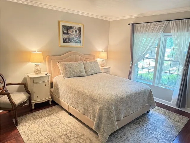 a bed room with a bed and a chair