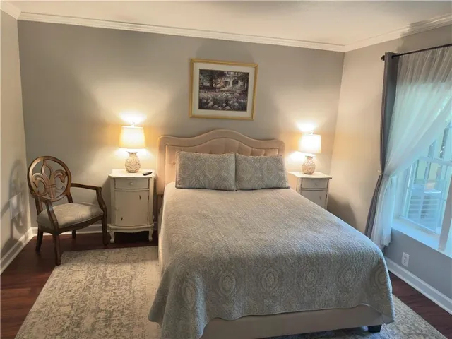 a bedroom with a bed chair and a window