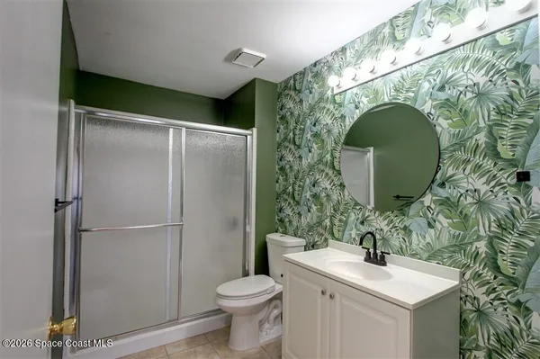 a bathroom with a sink and mirror with toilet