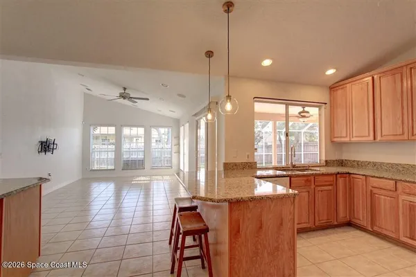 a large kitchen with kitchen island a sink stainless steel appliances and cabinets