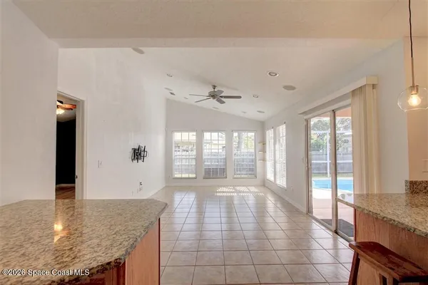 a large kitchen with granite countertop a large window and a counter space