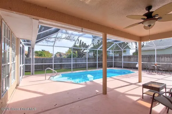 a view of a room with a wooden floor and fence
