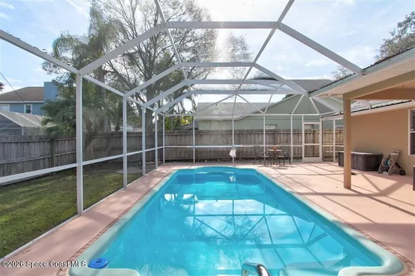 a view of a backyard with a swimming pool