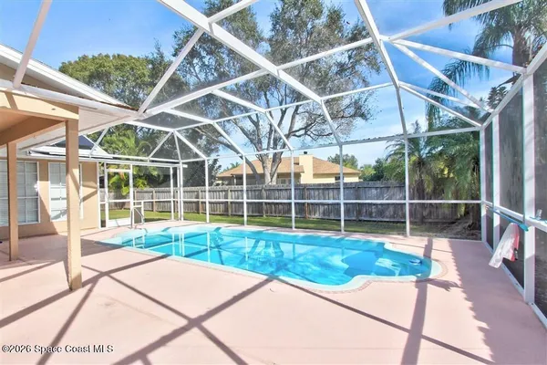 a view of a backyard with a swimming pool