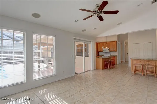 a view of a livingroom with furniture and a ceiling fan