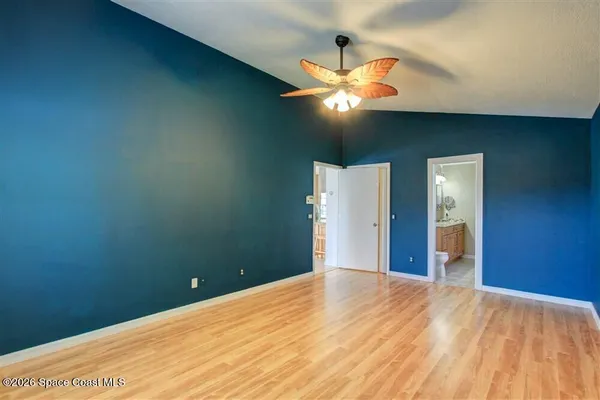 a view of a big room with a chandelier fan
