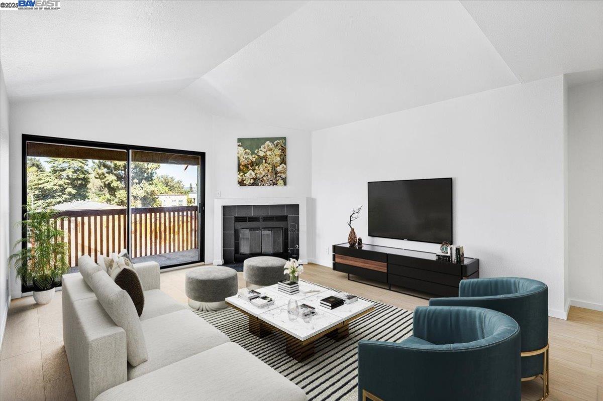 1318 B Street, Unit 314 Hayward, CA 94541 - Photo 11 of 20 a living room with furniture a flat screen tv and a large window