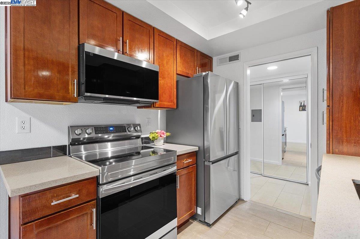 1318 B Street, Unit 314 Hayward, CA 94541 - Photo 8 of 20 a kitchen with stainless steel appliances a stove microwave and refrigerator