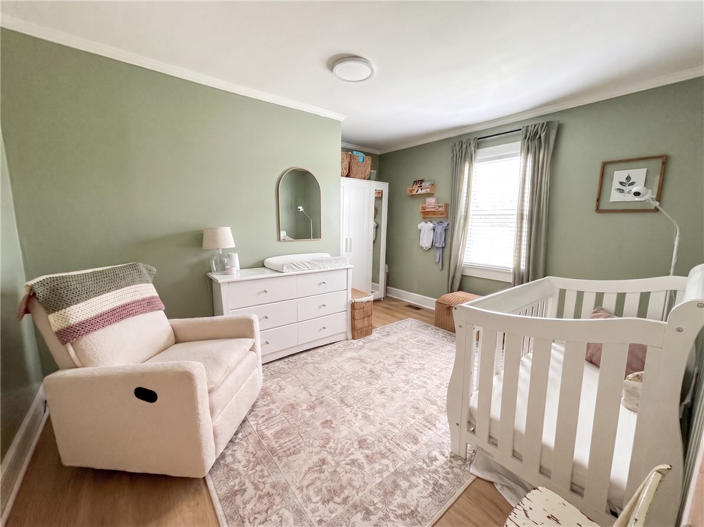 710 O Neal Street Belton, SC 29627 - Photo 17 of 18 A comforting nursery offers ample space for new beginnings, with bright natural light and hardwood-style flooring.