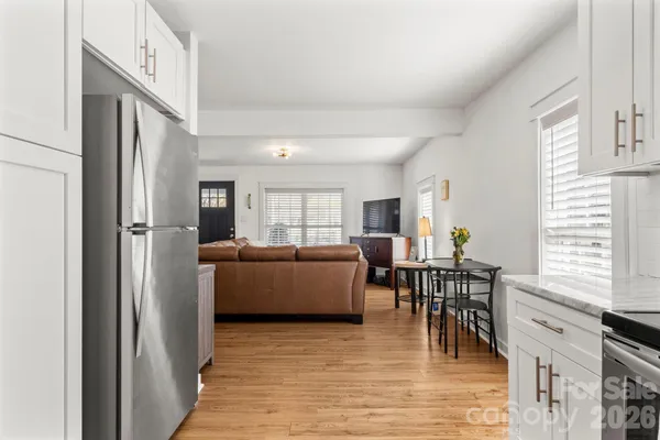 a dining room with furniture and wooden floor