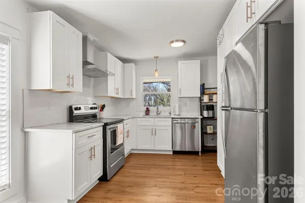 a kitchen with a refrigerator a sink and a stove