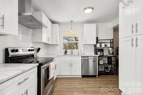 a kitchen with a white cabinets and white appliances