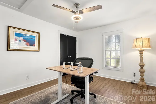 a view of workspace with wooden floor windows