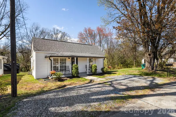 a view of a house with a yard and tree s
