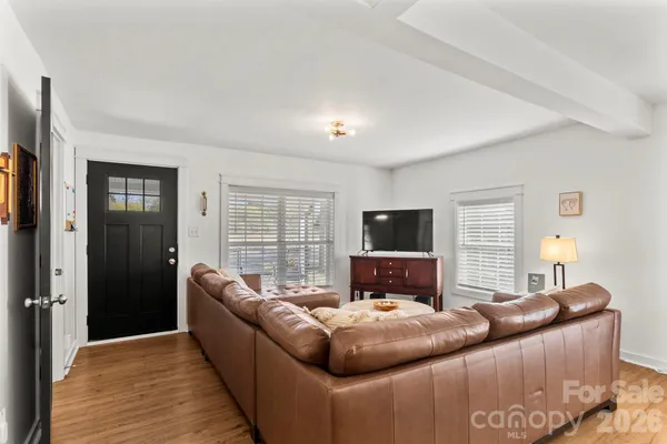 a bedroom with furniture and a flat screen tv