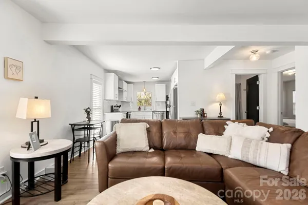 a living room with furniture and a lamp