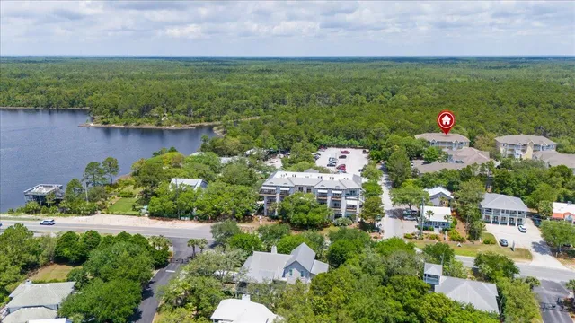 a aerial view of a house with a yard and lake view