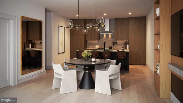 a kitchen with stainless steel appliances kitchen island granite countertop a table chairs refrigerator and microwave