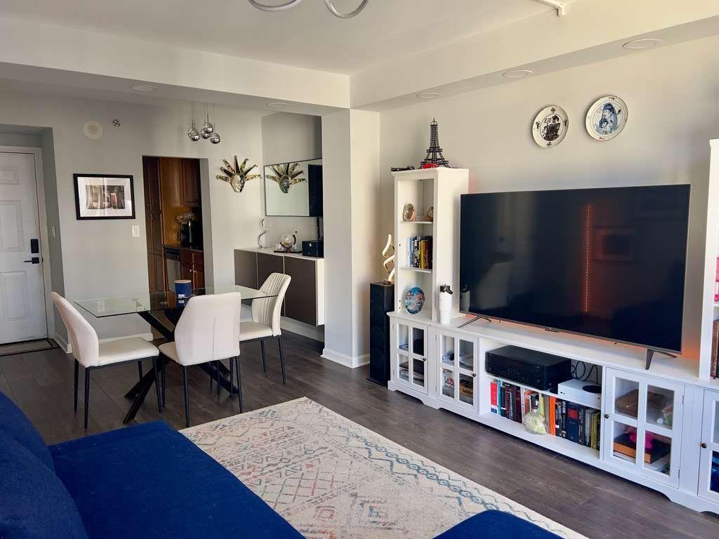 1280 West Peachtree Street Northwest, Unit 1113 Atlanta, GA 30309 - Photo 15 of 16 a living room with furniture and a flat screen tv