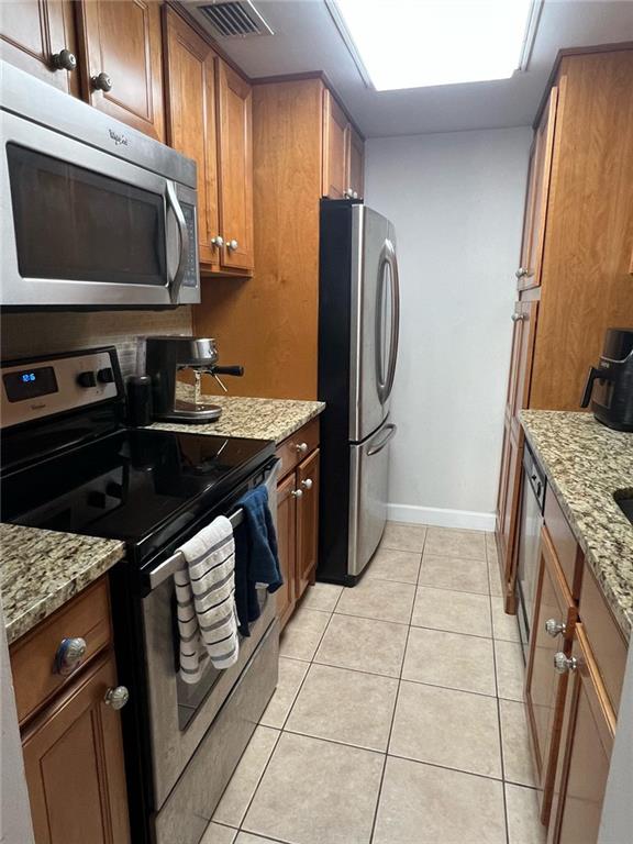 1280 West Peachtree Street Northwest, Unit 1113 Atlanta, GA 30309 - Photo 16 of 16 a kitchen with stainless steel appliances granite countertop a stove microwave and refrigerator