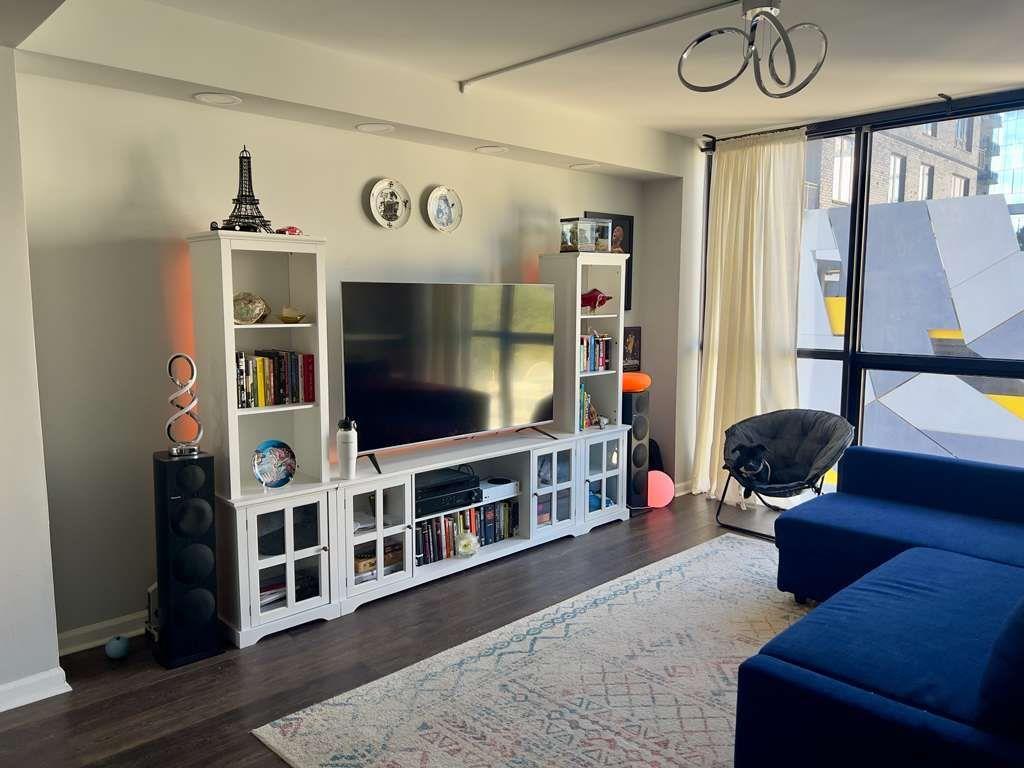 1280 West Peachtree Street Northwest, Unit 1113 Atlanta, GA 30309 - Photo 2 of 16 a living room with furniture and a flat screen tv