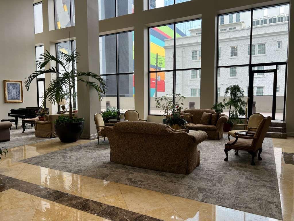 1280 West Peachtree Street Northwest, Unit 1113 Atlanta, GA 30309 - Photo 3 of 16 a living room with furniture floor to ceiling window and a flat screen tv