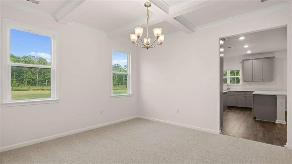 13593 Whitman Lane Covington, GA 30014 - Photo 11 of 25 a view of an empty room with a window and wooden floor