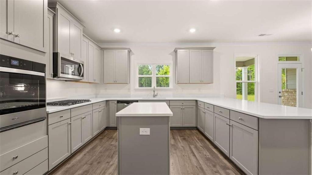 13593 Whitman Lane Covington, GA 30014 - Photo 16 of 25 a kitchen with stainless steel appliances granite countertop a sink stove and cabinets