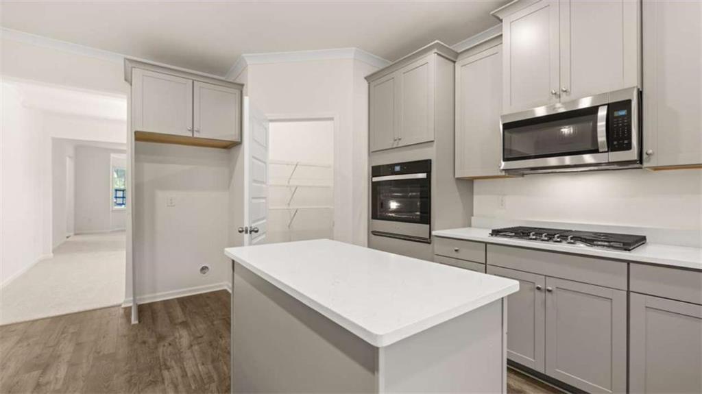 13593 Whitman Lane Covington, GA 30014 - Photo 18 of 25 a kitchen with white cabinets stainless steel appliances and sink