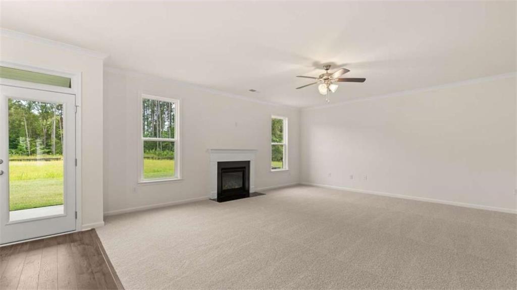 13593 Whitman Lane Covington, GA 30014 - Photo 22 of 25 an empty room with windows and fireplace
