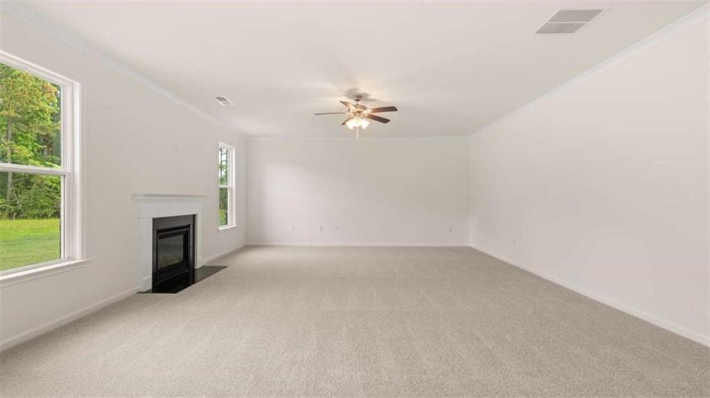 13593 Whitman Lane Covington, GA 30014 - Photo 24 of 25 an empty room with a fireplace and windows