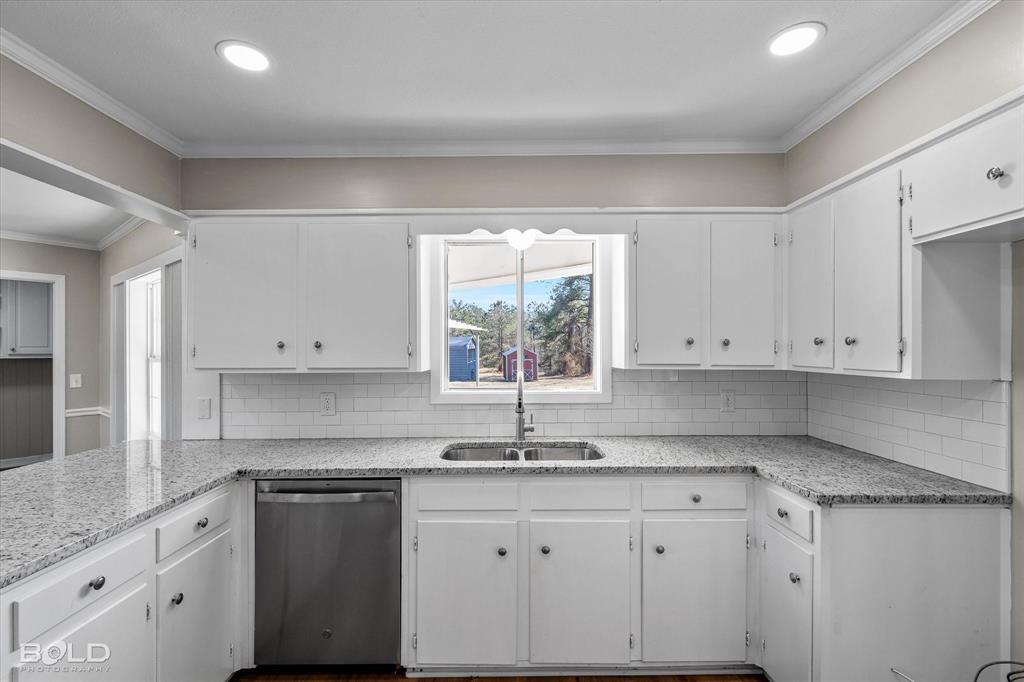 119 Stateny Lane Grand Cane, LA 71032 - Photo 12 of 40 a kitchen with granite countertop white cabinets white appliances and a sink