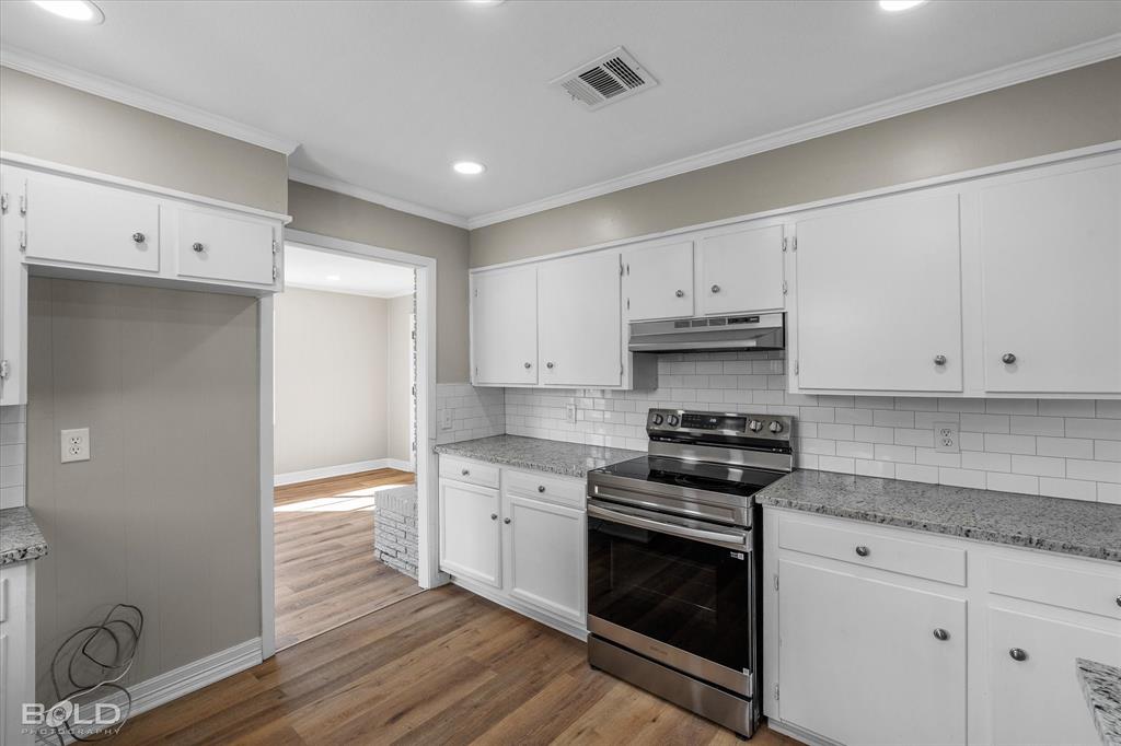 119 Stateny Lane Grand Cane, LA 71032 - Photo 14 of 40 a kitchen with granite countertop white cabinets and stainless steel appliances