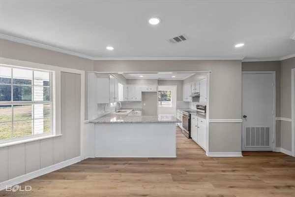a view of kitchen with cabinets and wooden floor