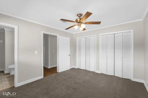 a view of a livingroom with a ceiling fan & entryway