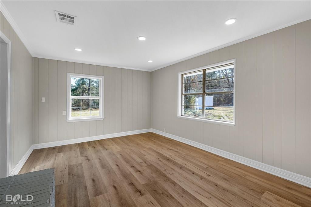 119 Stateny Lane Grand Cane, LA 71032 - Photo 7 of 40 a view of an empty room with wooden floor and a window