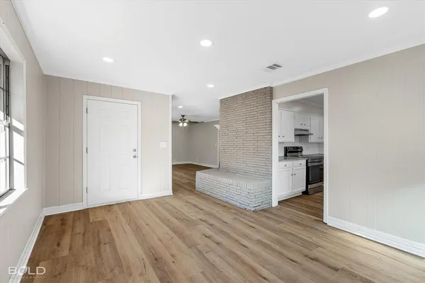 a view of a kitchen with wooden floor and a refrigerator