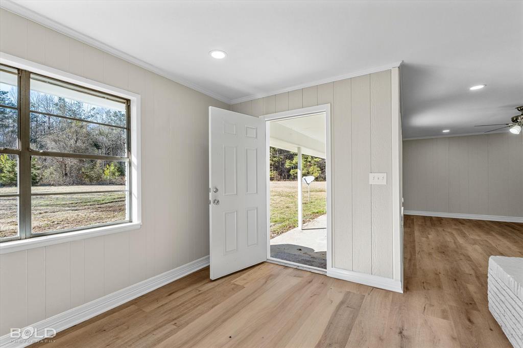 119 Stateny Lane Grand Cane, LA 71032 - Photo 9 of 40 an empty room with wooden floor and windows