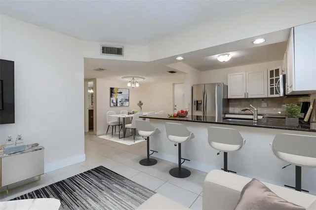 a kitchen with stainless steel appliances granite countertop a sink and cabinets