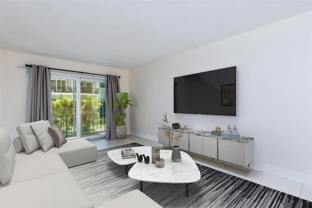 3000 Northeast 5th Terrace, Unit 110A Wilton Manors, FL 33334 - Photo 16 of 30 a living room with furniture and a flat screen tv