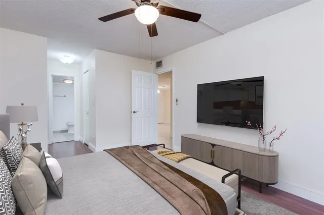 a bedroom with a bed and a flat screen tv